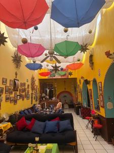a living room with umbrellas hanging from the ceiling at Hostel Casa Zalaoui in Guadalajara