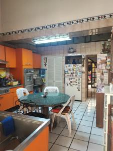 a kitchen with a table and chairs in it at Hostel Casa Zalaoui in Guadalajara