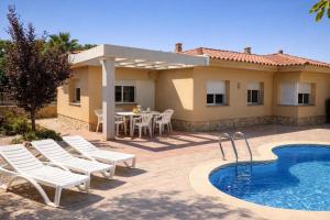 a patio with a table and chairs and a pool at Casa Mañet - "Pet Friendly - Piscina Privada - Playa - BBQ - Parking - Delta de l'Ebre - Riumar" in Riumar