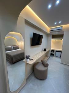 a bedroom with a bed and a large mirror at Ionian View B&B in Himare
