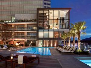 a building with a swimming pool next to a building at Fairmont Pacific Rim in Vancouver