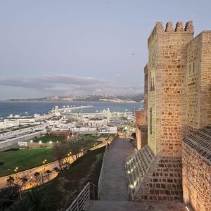 a view of a city from a castle at maison bleu hajja in Tangier