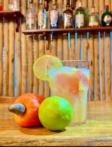a glass of fruit with a lime and a limeassi at Jangadas do Pontal in Fortim +41 photos