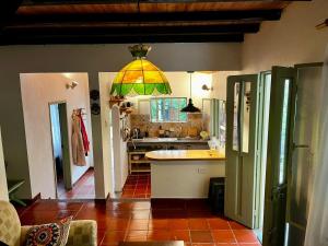a kitchen with a light hanging from the ceiling at Tu Refugio en el Campo in San Francisco