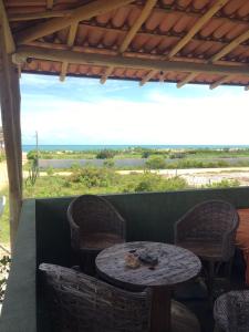 a table and two chairs and a table with a view of the ocean at Jangadas do Pontal in Fortim