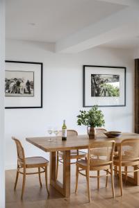 a dining room with a wooden table and chairs at Bay Properties Bridgewood in Yamba +12 photos
