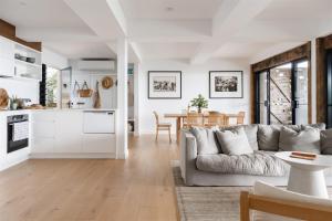 a living room with a couch and a table at Bay Properties Bridgewood in Yamba