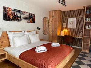 a bedroom with a bed with two towels on it at Alpenfels Apartments - Zwieselstein in Sölden