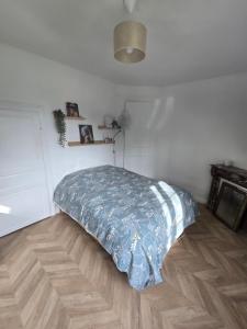 a bed in a room with a wooden floor at La Hacienda Verde in Heudreville-sur-Eure +13 photos