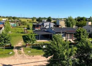 a group of houses in a field with trees at Complejo Aura in Colón