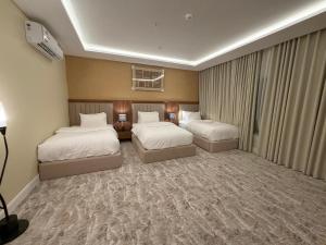 a hotel room with two beds and a television at فندق ستل أوشن in Jazan +79 photos