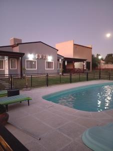 a swimming pool in front of a house at Complejo Aura in Colón +33 photos