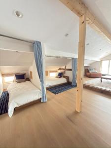 a bedroom with two bunk beds in a attic at Kogane Hills Niseko in Rankoshi