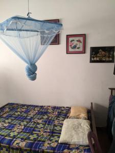 a bedroom with a bed with a blue ceiling at Stay in flying in Katunayaka