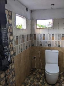 a bathroom with a toilet and a window and a shower at Stay in flying in Katunayaka