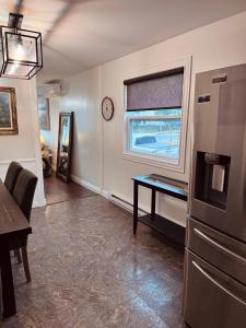a living room with a table and a window at The Comfort Pearl in Topsail
