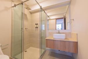 a bathroom with a glass shower and a sink at Alcaré Rooms Cartagena in Cartagena de Indias +32 photos