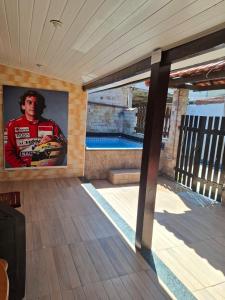 a wall with a picture of a race car on it at Casas do Pescador in Maricá