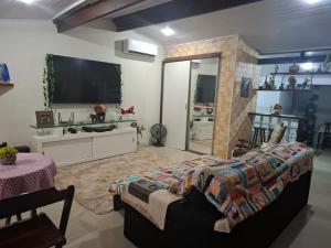 a living room with a bed and a fireplace at Casas do Pescador in Maricá