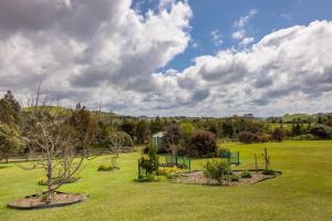 a field with trees and plants in a park at The Shack in Mangonui