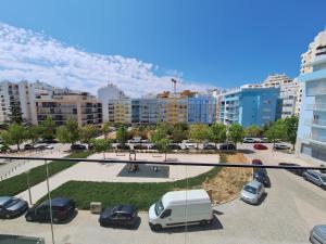 a view of a parking lot with cars parked at Edifício da Vinha - Ocean Breeze Apartments in Armação de Pêra