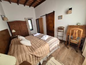a bedroom with a bed and a chair in it at Casa Nido San Javier in San Javier