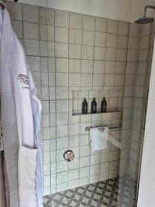 a bathroom with a shower with two bottles on a shelf at Casa Nido San Javier in San Javier +29 photos