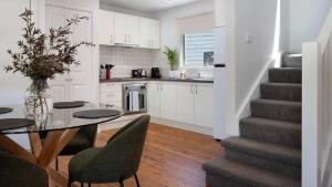 a kitchen with a table and chairs and a staircase at Kingfisher Loft in Daylesford +9 photos