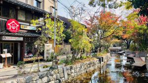 a canal in a city with a stop sign at Kyoto G in Kyoto