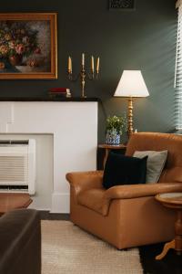 a living room with a couch and a fireplace at Whimsy Cottage, Beachside retreat, Outdoor bath in Kingston Beach