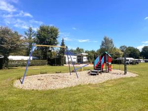 a park with a playground with two swings at de Krekel in Hulshorst