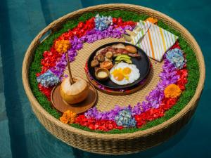 a breakfast plate with eggs and vegetables in a basket at Villa Sun Soul - Brand New 2bed Villa w Rice Field View in Ubud