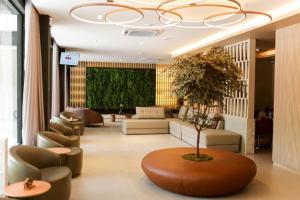 a lobby with a couch and chairs and a tree at China Park Eco Resort in Domingos Martins +31 photos