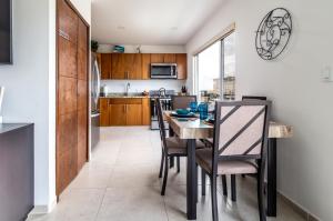 a kitchen and dining room with a table and chairs at Ocean View, Amazing Sunsets, AC, Pool in Tijuana