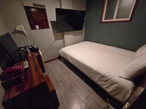 a room with two beds and a television in it at a 모텔 in Seoul