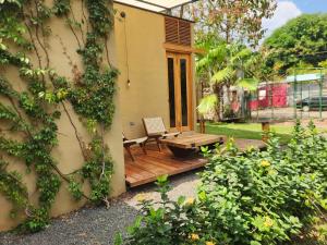 a patio with a wooden table and a chair at Mango Soul in El Zonte