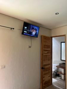a flat screen tv on the wall of a room at Mango Soul in El Zonte