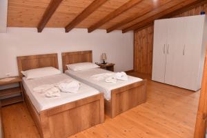 a bedroom with two beds with towels on them at Guesthouse Aloe in Berat