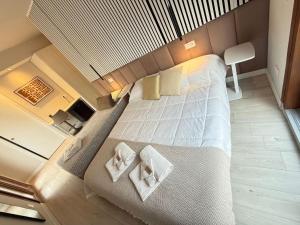 a bedroom with a large bed with two pillows at La suite N4-elegant suite near lido beach in Alghero