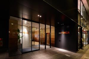 a store front of a forza store at night at Hotel Forza Nagasaki in Nagasaki