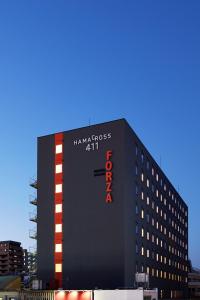 a large black building with a sign on it at Hotel Forza Nagasaki in Nagasaki