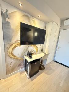 a desk in a room with a painting on the wall at La suite N4-elegant suite near lido beach in Alghero