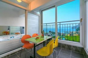 a dining room with a table and chairs and a large window at Geoje Haneul Ari Pension in Geoje +13 photos