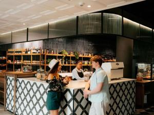 a man and a woman standing at a bar at Mövenpick Hotel Windhoek in Windhoek +111 photos