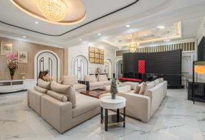 a large living room with couches and a piano at Swiss-Belexpress Palu in Palu