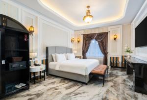 a bedroom with a white bed and a television at Swiss-Belexpress Palu in Palu +35 photos