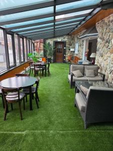a living room with green grass and tables and chairs at Loft La Pause Orford in Magog-Orford