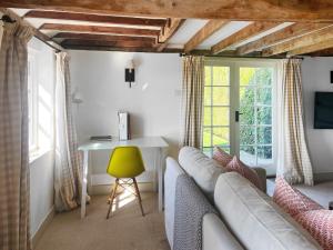 a living room with a couch and a table at Prospect Cottage in Wittersham