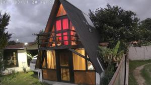 a small house with a gambrel roof at Casa paula in San Agustín +4 photos