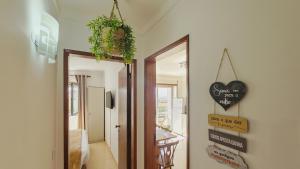 a hallway with a door leading to a dining room at Baleal Beach Stay in Baleal